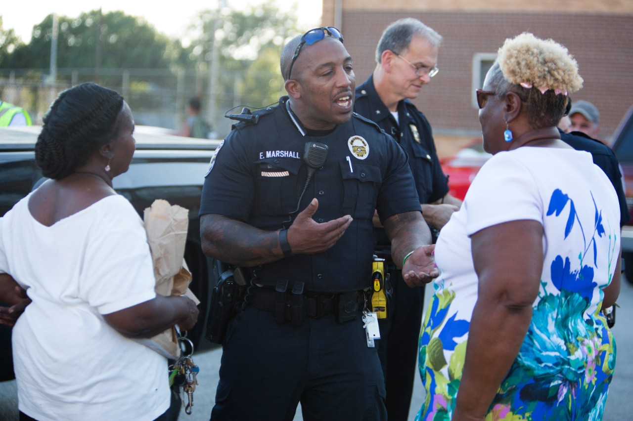 Two police officers meeting with community leaders.