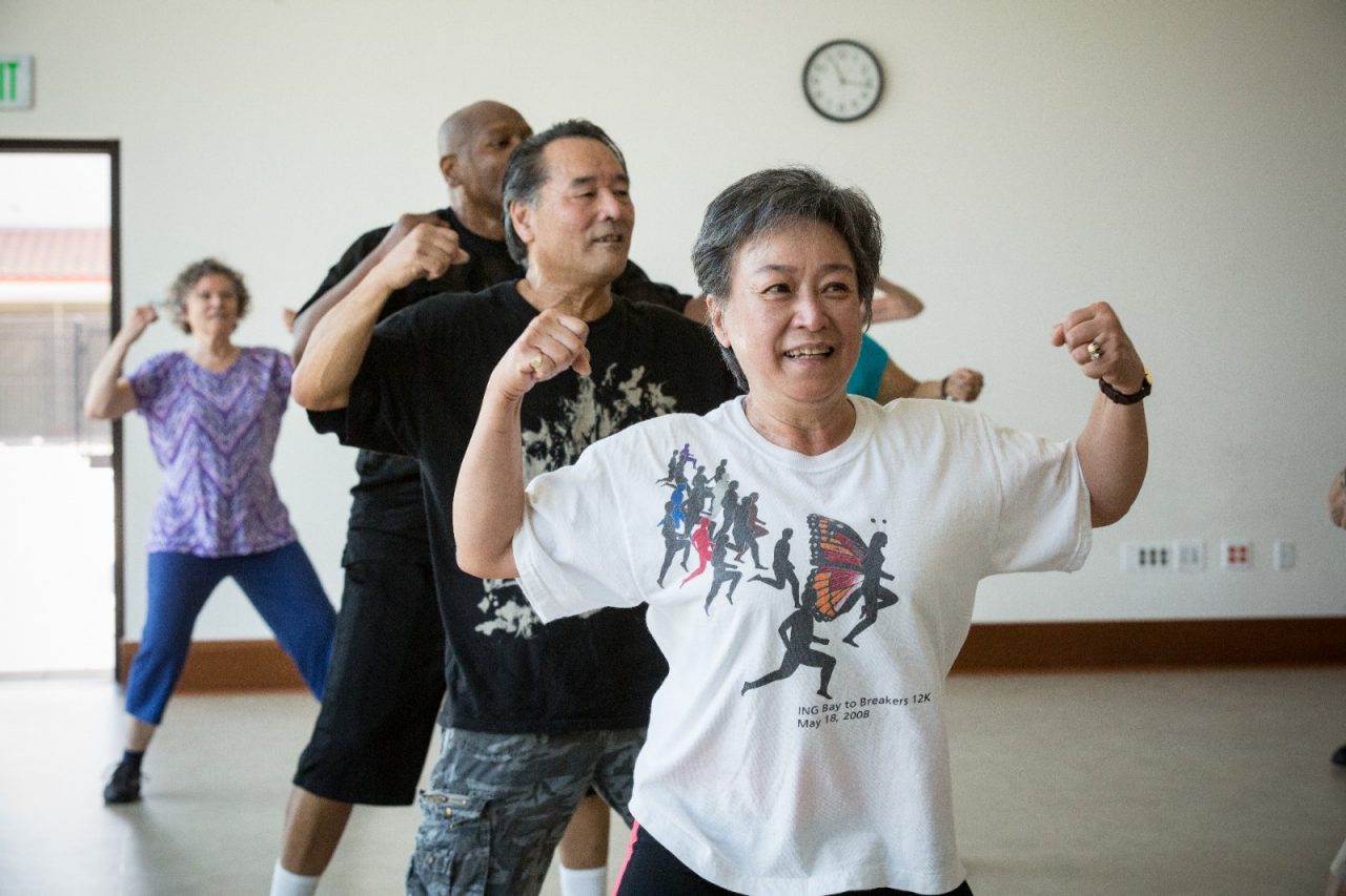 Adults participating in an exercise class.