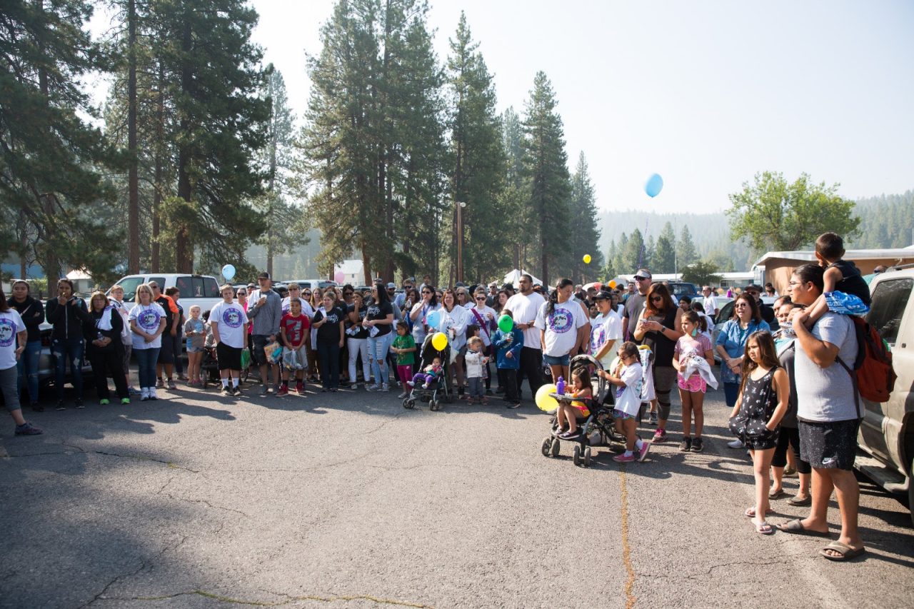 A large group gathering for an outdoor community event.