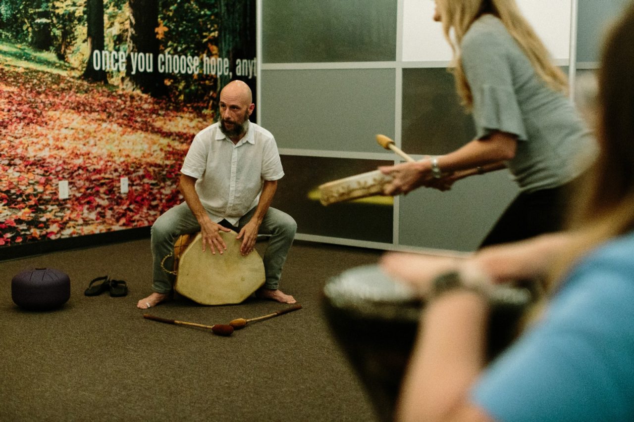 People attending a drumming circle.