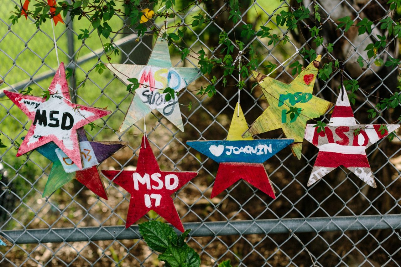 A fence adorned with memorials, remembering people who perished from gun violence.