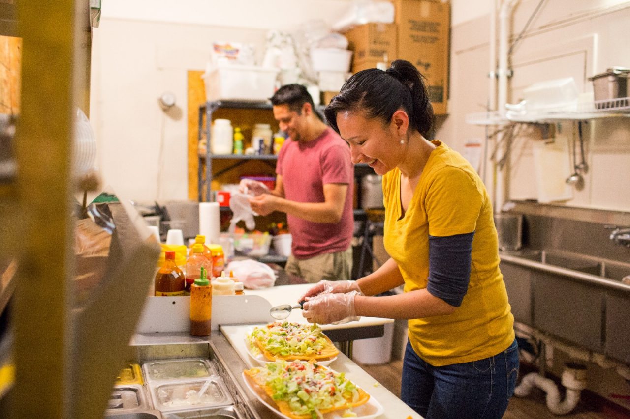 Business owners Nora Arreola and Saul Aguilar prepare food at El Mercadito Mexican Store in Leadville, Colorado.