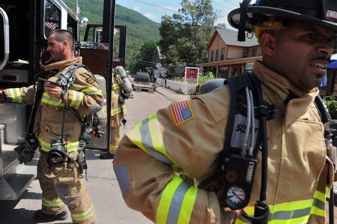 PHOENICIA, NEW YORK - SEPTEMBER 01: Members of the Maybrook Volunteer Fire Department respond to a fire call in Phoenicia, New York. Volunteer firefighters, Ted Ginquitti (left, short cropped hair, Release # 14) and Michael Soto (darker skin with tan shorts, Release #17) stand at the ready in their turn-out gear. Hurricane Irene dropped large amounts of rain on the Catskills causing major flooding in many towns and villages. Photo by Matt Moyer

RELEASES:
Release # 14 : Ted Ginquitti (short hair)
Release # 16: Patrick Romanik (glasses)
Release # 17: Michael Soto (darker skin), PHOENICIA, NEW YORK - SEPTEMBER 01: Members of the Maybrook Volunteer Fire Department respond to a fire call in Phoenicia, New York. Volunteer firefighters, Ted Ginquitti (left, short cropped hair, Release # 14) and Michael Soto (darker skin with tan shorts, Release #17) stand at the ready in their turn-out gear. Hurricane Irene dropped large amounts of rain on the Catskills causing major flooding in many towns and villages. Photo by Matt Moyer

RELEASES:
Release # 14 : Ted Ginquitti (short hair)
Release # 16: Patrick Romanik (glasses)
Release # 17: Michael Soto (darker skin)